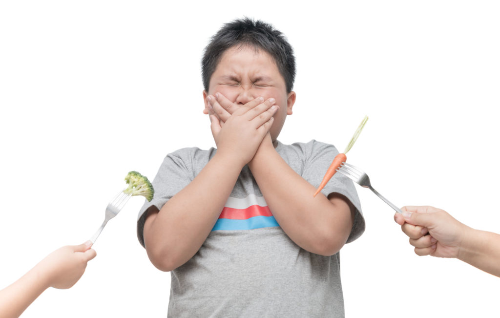 Young male Picky Eater Refusing Vegetables